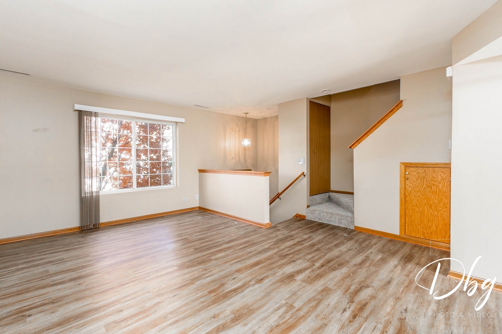 31 South Treehouse Lane, Unit 31 Round Lake, IL 60073 - Photo 5 of 26 a view of an empty room with wooden floor and a window