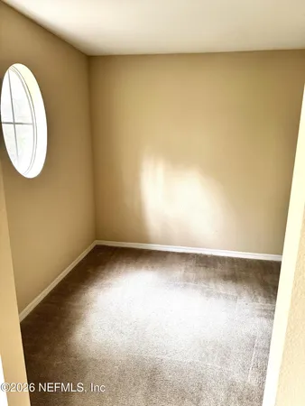 a view of a room with wooden floor and white walls