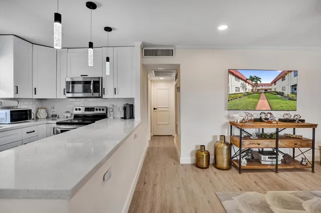 a kitchen with stainless steel appliances a stove a refrigerator and a sink