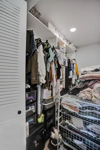 a bedroom with a large bed and a flat screen tv