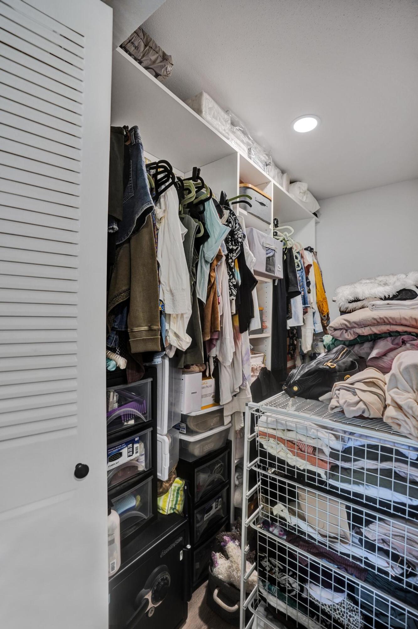 40 Saxony A Delray Beach, FL 33446 - Photo 18 of 41 a view of walk in closet with clothes and shoes