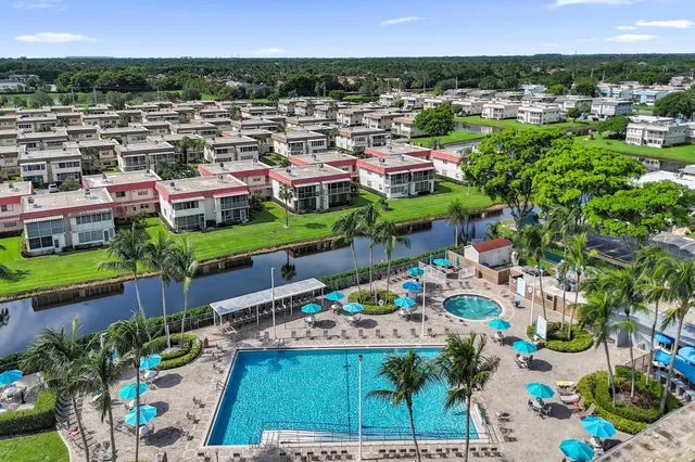 an aerial view of a residential houses with outdoor space