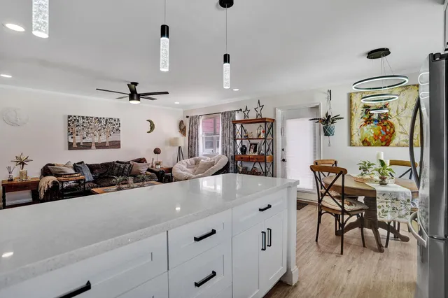 a kitchen with a wooden floor and breakfast area