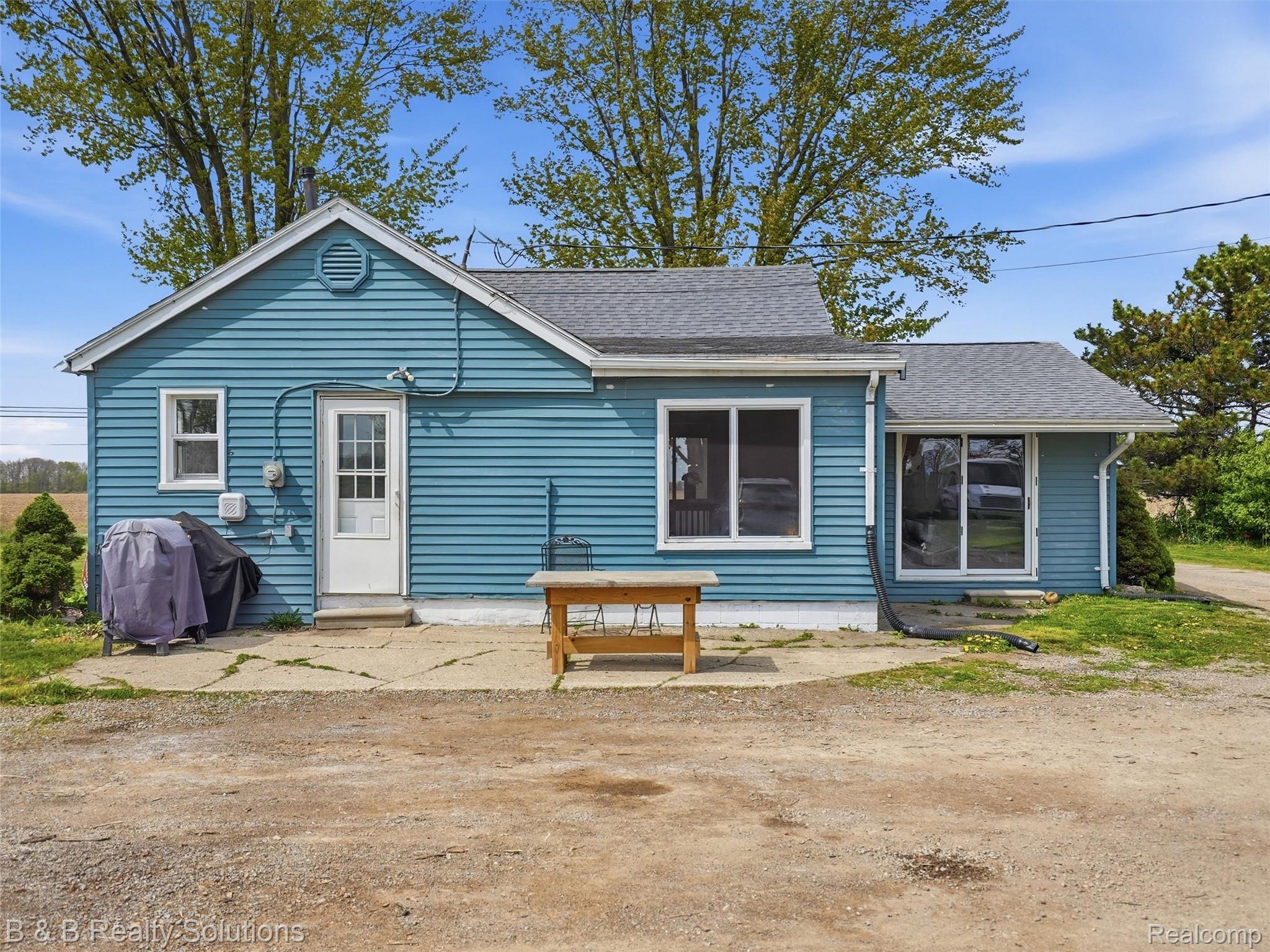 Back of property with a shingled roof