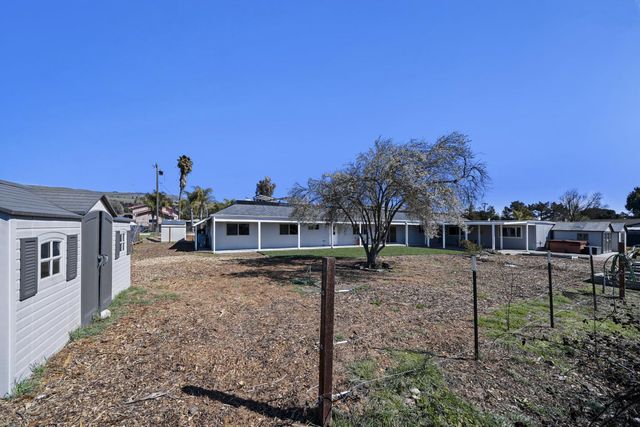 a view of a house with a backyard and porch