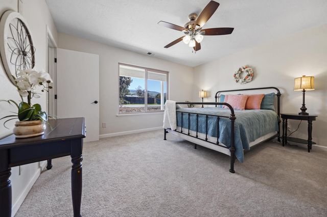 a bed room with a bed window and a table