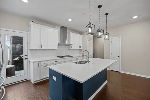 a kitchen with a sink a stove a microwave and cabinets