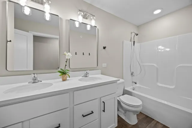 a bathroom with 2 sink and a mirror