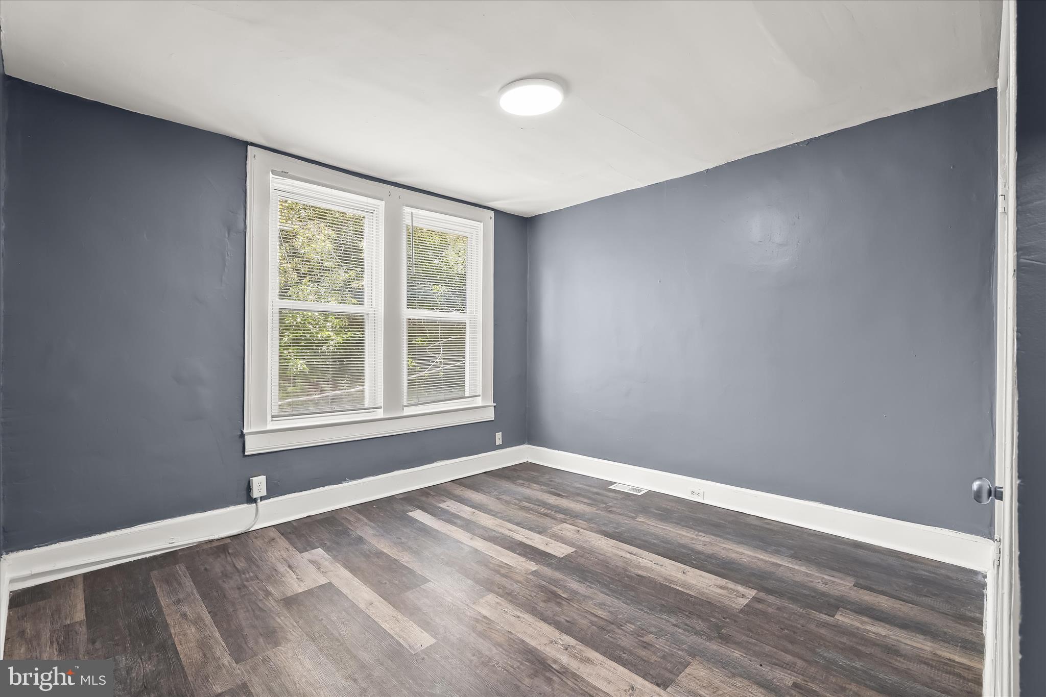 3534 Overview Road Baltimore, MD 21215 - Photo 16 of 28 a view of an empty room with wooden floor and a window