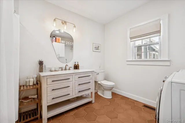 a bathroom with a tub sink and mirror