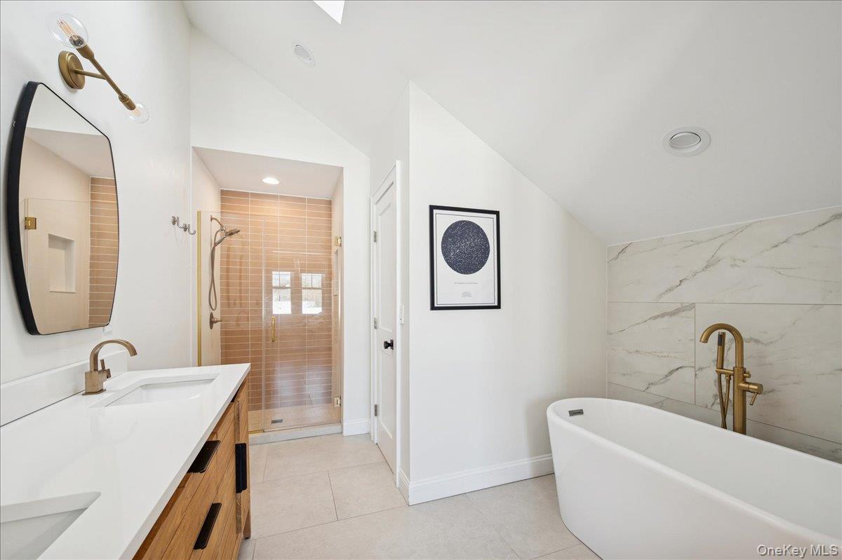 36 Atlantic Avenue Blue Point, NY 11715 - Photo 32 of 46 Primary bedroom bath with double sink vanity and stand-alone soaker tub