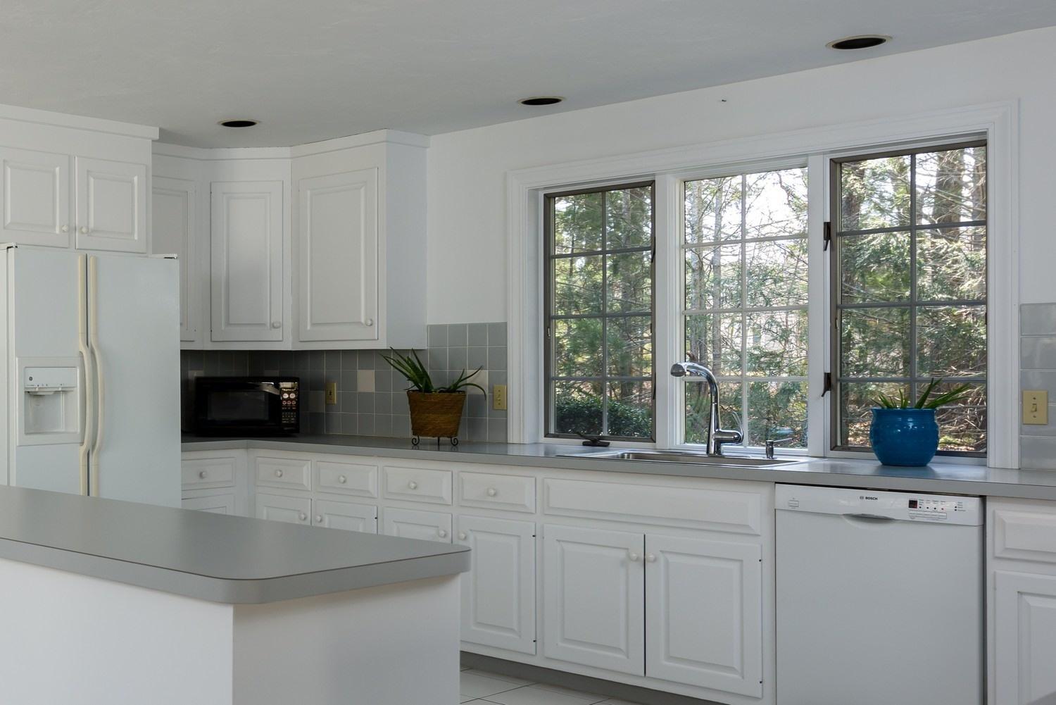 25 Oakdale Path Osterville, MA 02655 - Photo 12 of 21 a kitchen with stainless steel appliances granite countertop a stove a sink and a granite counter tops