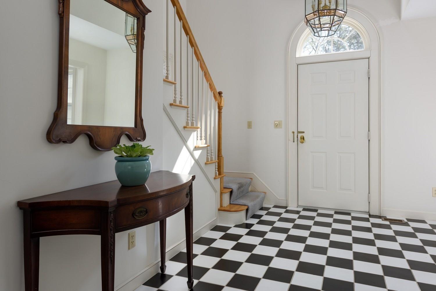 25 Oakdale Path Osterville, MA 02655 - Photo 4 of 21 a view of a hallway with windows and flower pot
