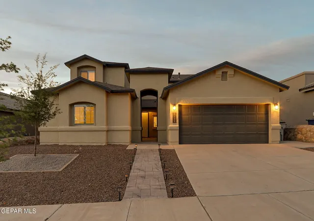 a front view of a house with a yard and garage