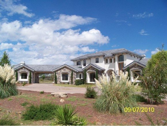 3680 West L Bar L Road Prescott, AZ 86305 - Photo 1 of 24 a front view of a house with a garden
