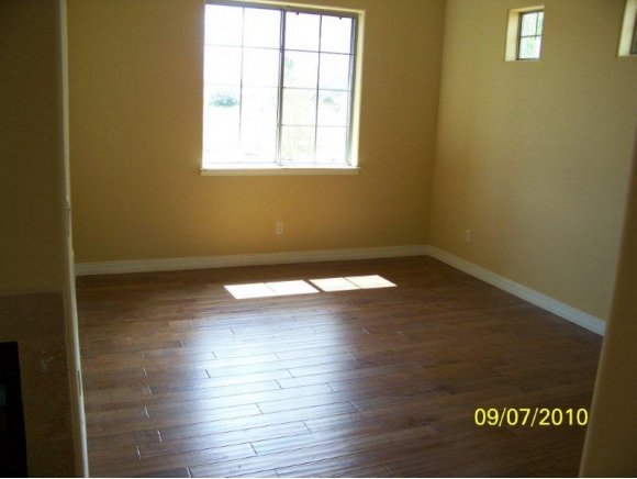 3680 West L Bar L Road Prescott, AZ 86305 - Photo 19 of 24 an empty room with wooden floor and windows