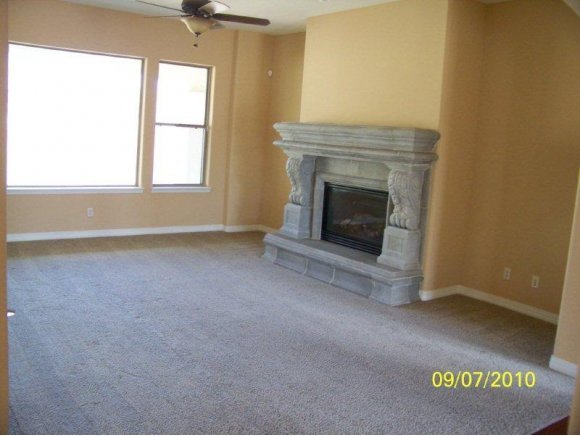 3680 West L Bar L Road Prescott, AZ 86305 - Photo 4 of 24 an empty room with windows and fireplace