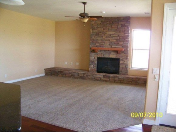 3680 West L Bar L Road Prescott, AZ 86305 - Photo 7 of 24 an empty room with a fireplace