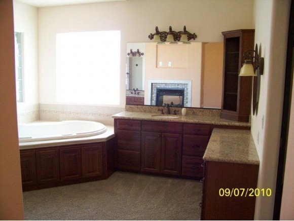 3680 West L Bar L Road Prescott, AZ 86305 - Photo 9 of 24 a bathroom with a granite countertop sink a mirror and a bathtub