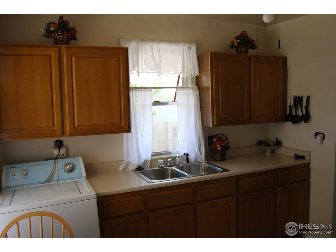 7702 Raleigh Street Westminster, CO 80030 - Photo 11 of 14 WASHER IN KITCHEN