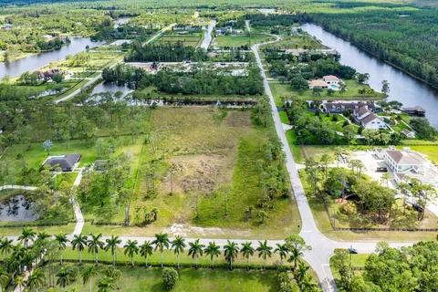 an aerial view of residential houses with outdoor space and swimming pool