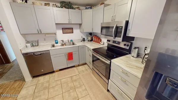 a kitchen with a sink stove and microwave