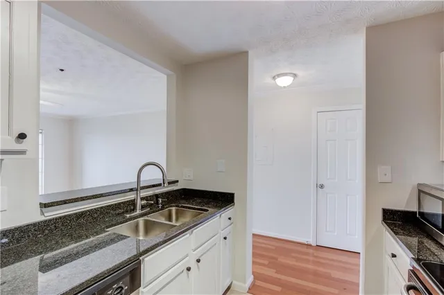a kitchen with a sink and cabinets