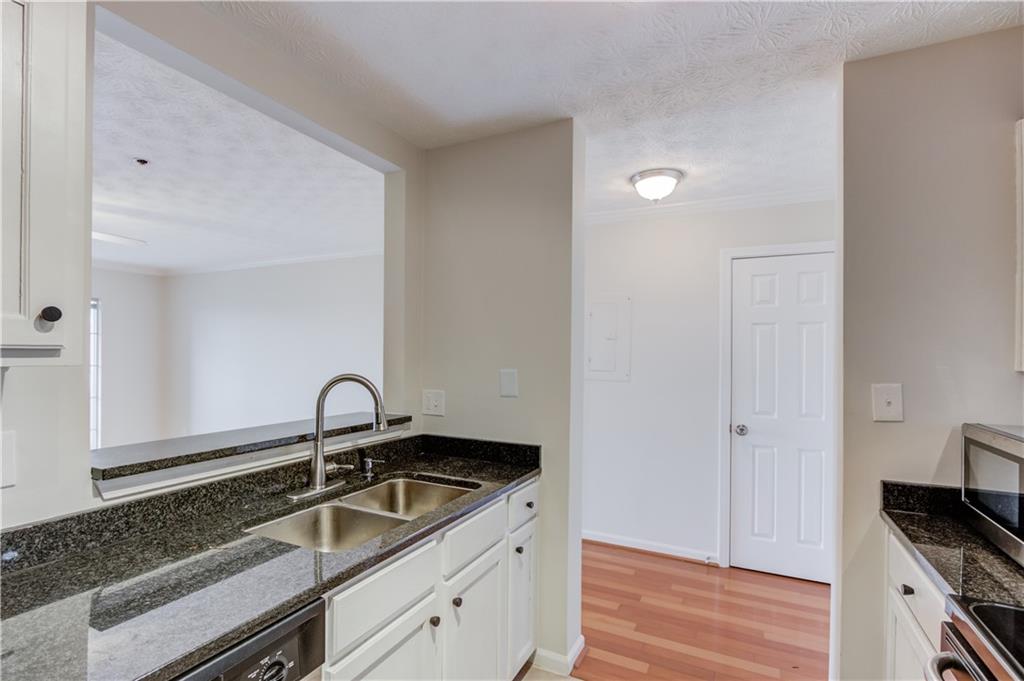 970 Sidney Marcus Boulevard Northeast, Unit 2403 Atlanta, GA 30324 - Photo 12 of 41 a kitchen with a sink and cabinets