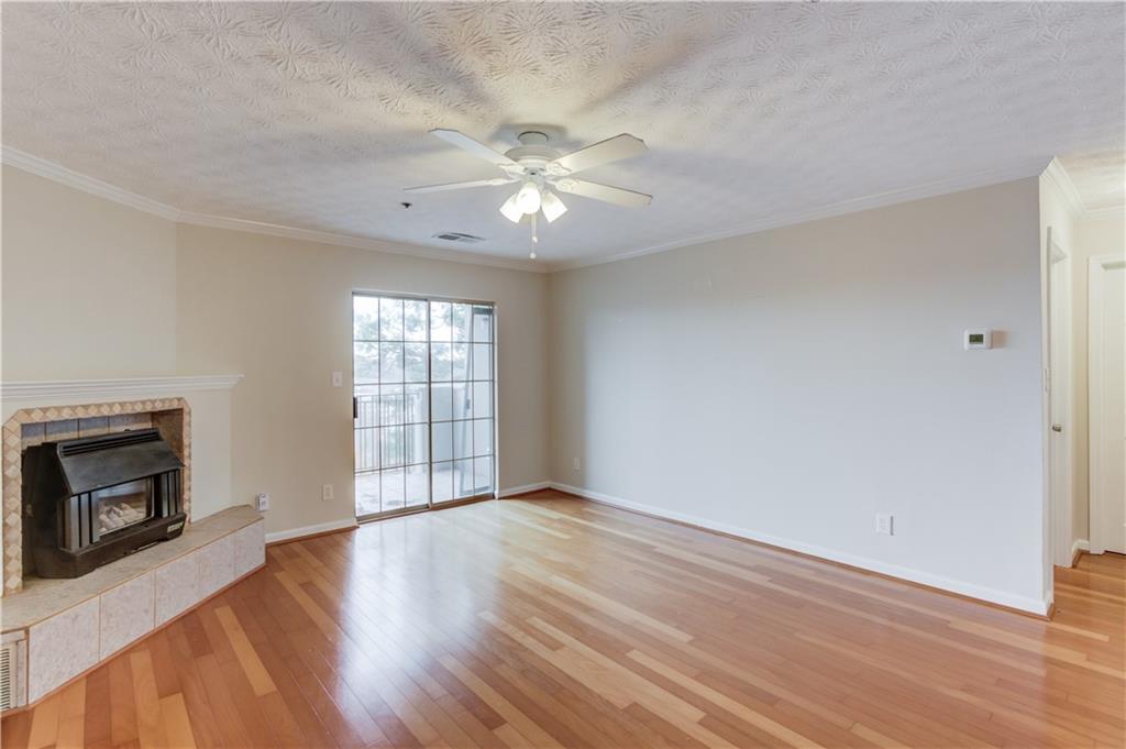 970 Sidney Marcus Boulevard Northeast, Unit 2403 Atlanta, GA 30324 - Photo 15 of 41 wooden floor in an empty room with a window