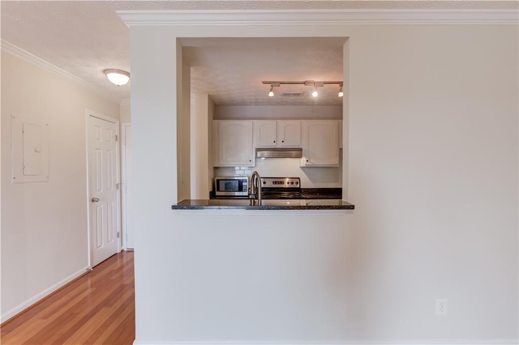 970 Sidney Marcus Boulevard Northeast, Unit 2403 Atlanta, GA 30324 - Photo 17 of 41 a view of a refrigerator in kitchen and wooden floor