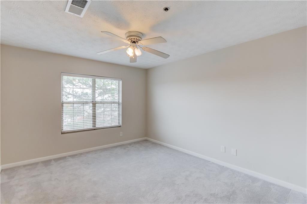 970 Sidney Marcus Boulevard Northeast, Unit 2403 Atlanta, GA 30324 - Photo 20 of 41 an empty room with a window and a fan