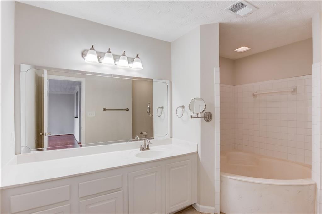 970 Sidney Marcus Boulevard Northeast, Unit 2403 Atlanta, GA 30324 - Photo 22 of 41 a bathroom with a double vanity sink mirror and shower