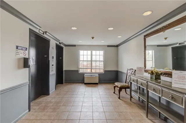 a view of a hallway with furniture and large window