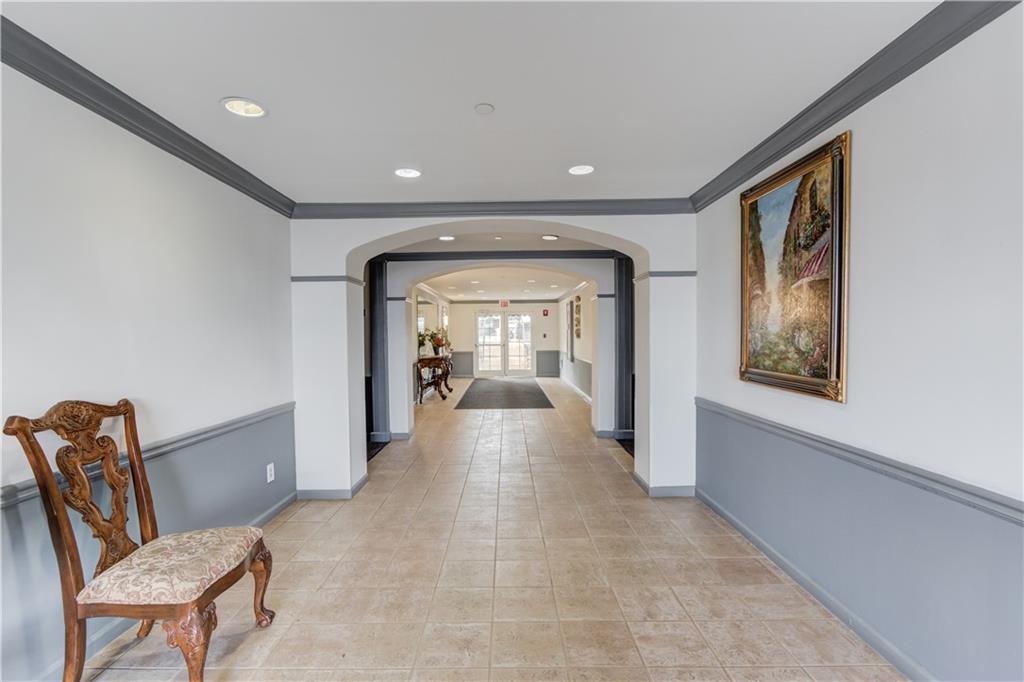 970 Sidney Marcus Boulevard Northeast, Unit 2403 Atlanta, GA 30324 - Photo 32 of 41 a view of a hallway with furniture and large window