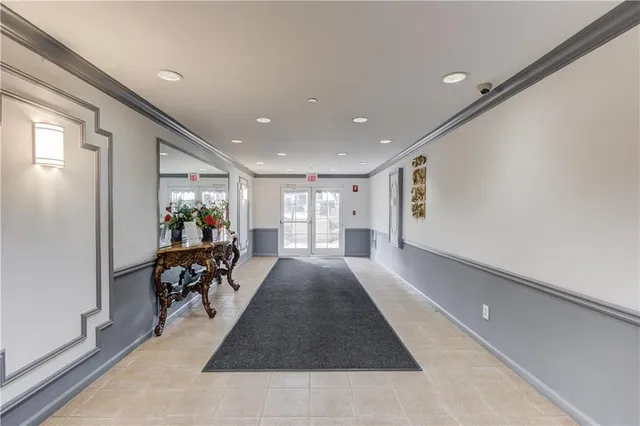 an aerial view of a house with swimming pool and large trees