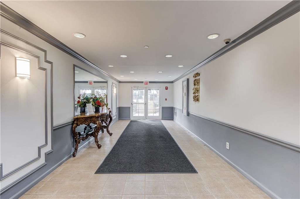 970 Sidney Marcus Boulevard Northeast, Unit 2403 Atlanta, GA 30324 - Photo 33 of 41 a view of a hallway with wooden floor and furniture