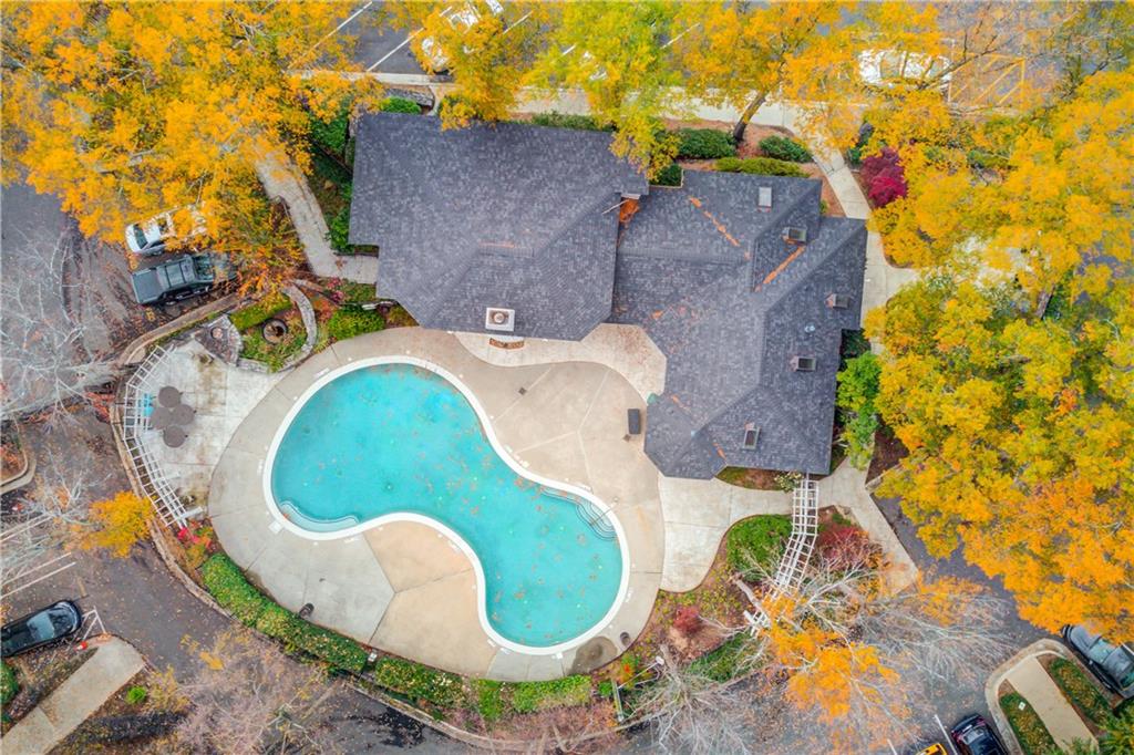 970 Sidney Marcus Boulevard Northeast, Unit 2403 Atlanta, GA 30324 - Photo 35 of 41 an aerial view of a house with swimming pool and large trees