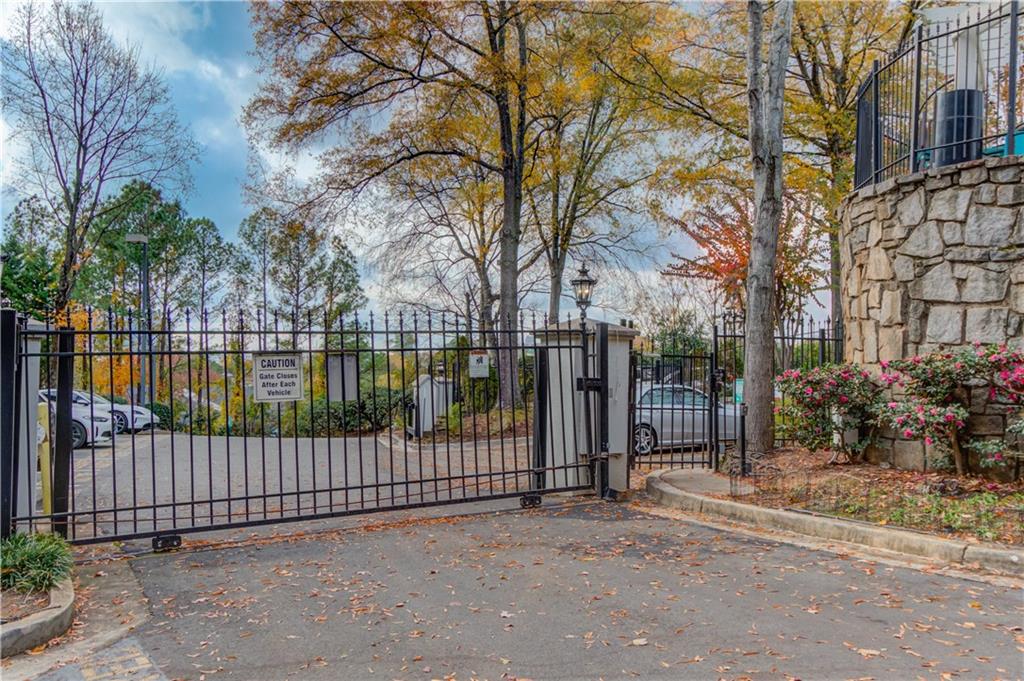 970 Sidney Marcus Boulevard Northeast, Unit 2403 Atlanta, GA 30324 - Photo 5 of 41 a view of a street with a fence and a trees
