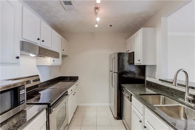 a kitchen that has a sink and a stove