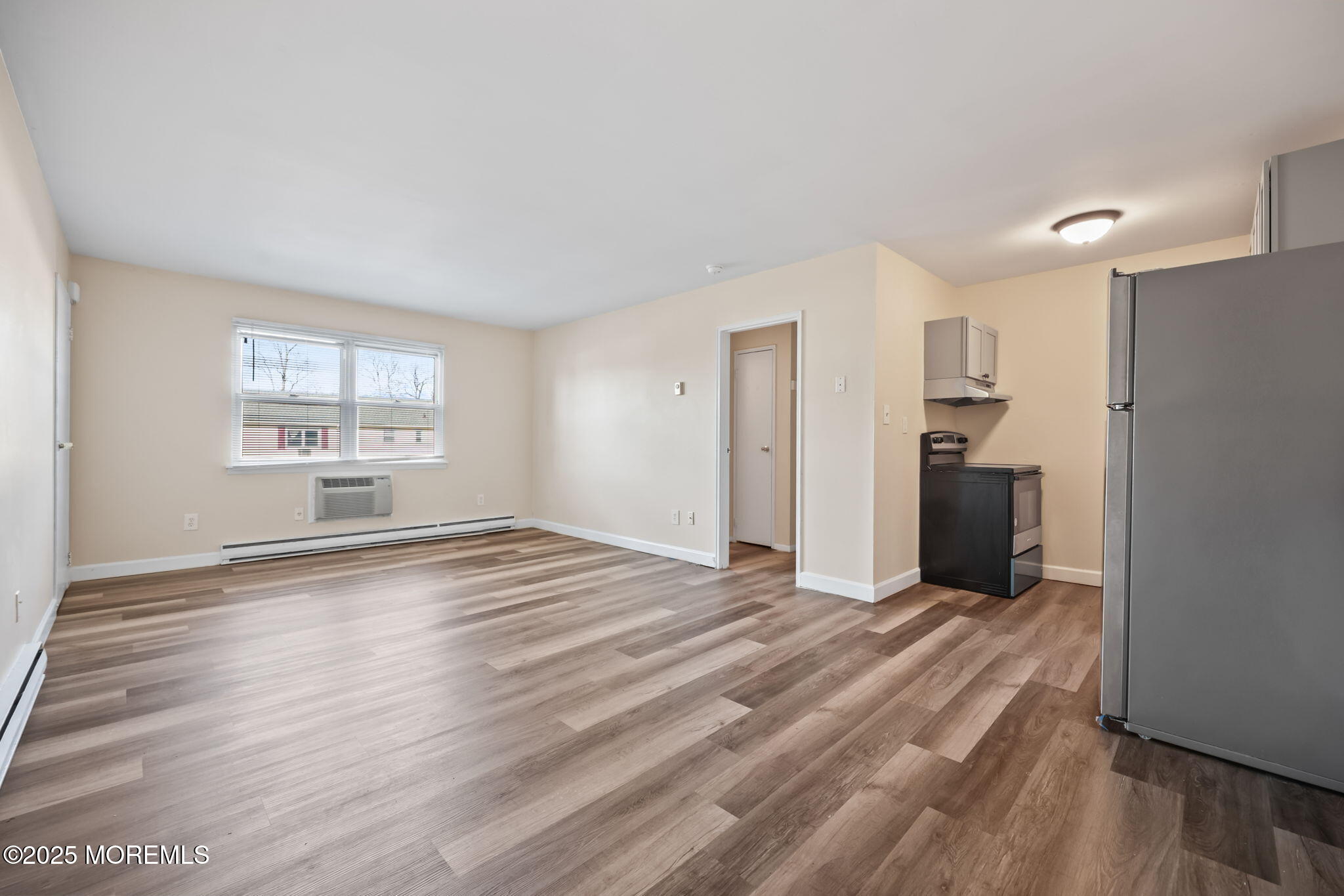 175 Buckelew Avenue, Unit BLDG 2 14 Jamesburg, NJ 08831 - Photo 11 of 31 a view of empty room with wooden floor and window