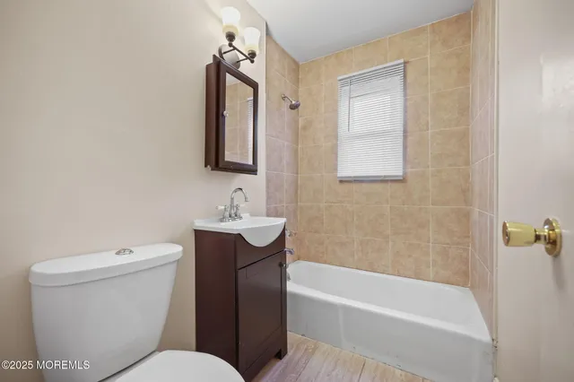 a bathroom with a toilet a sink and bathtub
