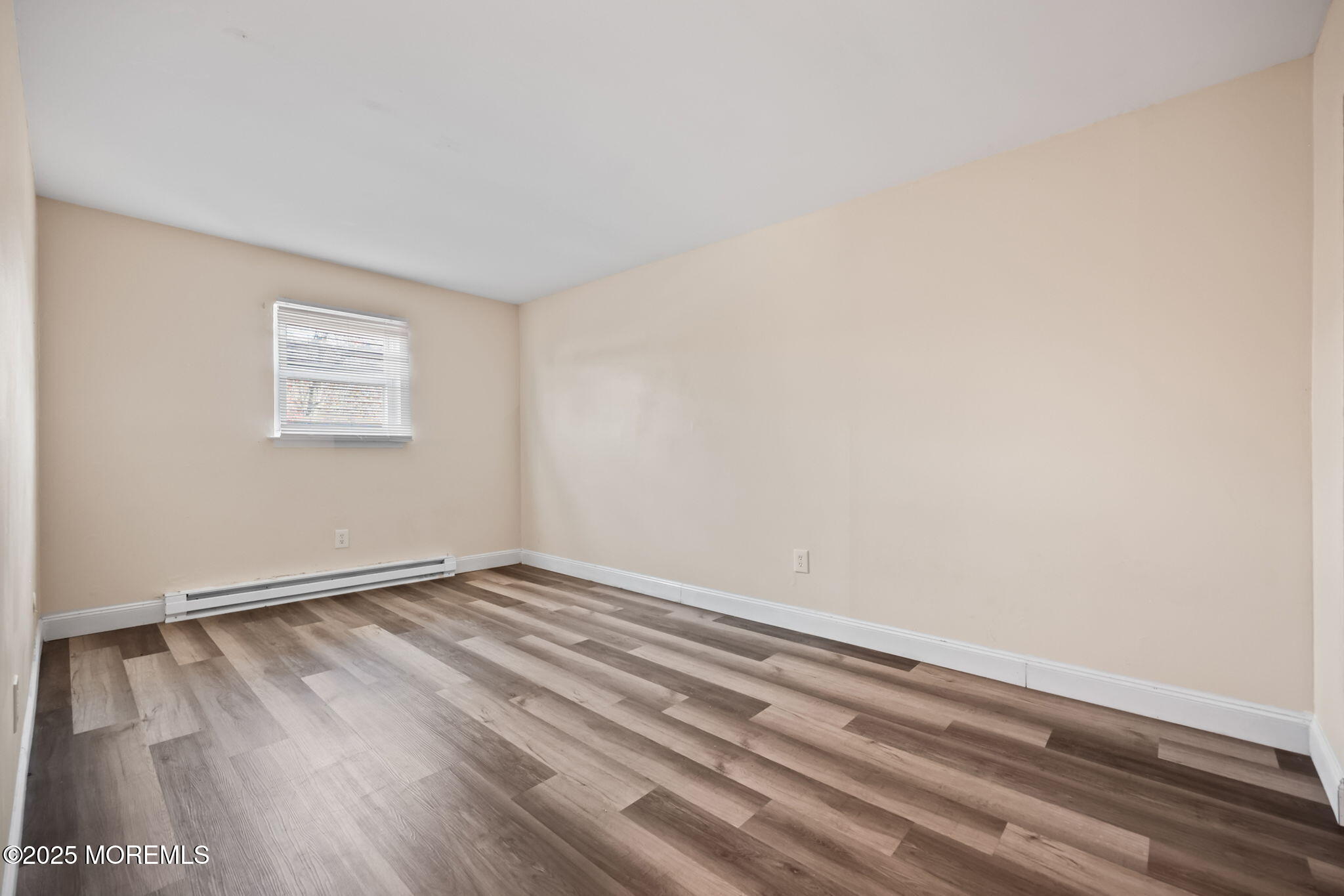 175 Buckelew Avenue, Unit BLDG 2 14 Jamesburg, NJ 08831 - Photo 26 of 31 a view of an empty room with wooden floor and a window
