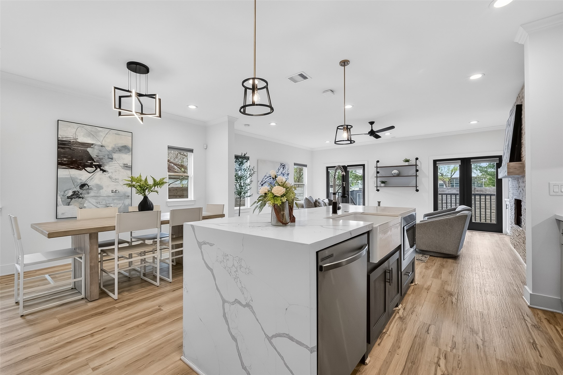 a kitchen with a dining table chairs wooden floor and appliances