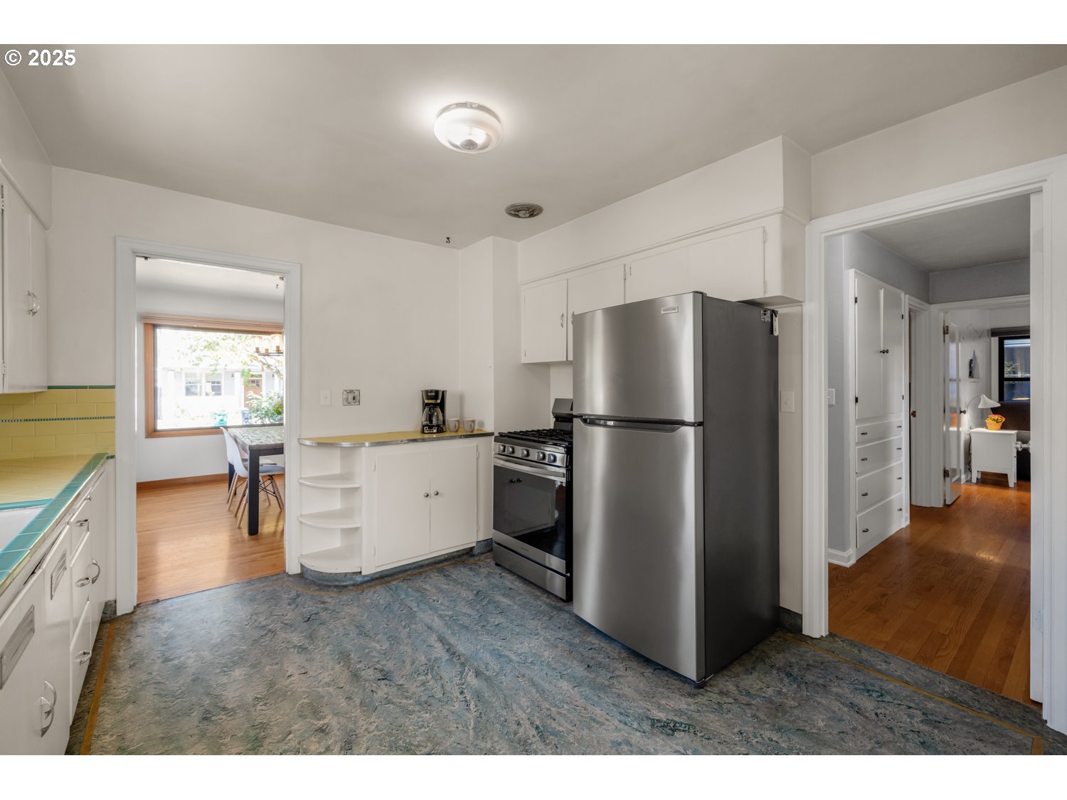 4016 Southeast Cora Street Portland, OR 97202 - Photo 12 of 30 a kitchen with stainless steel appliances a refrigerator and a stove