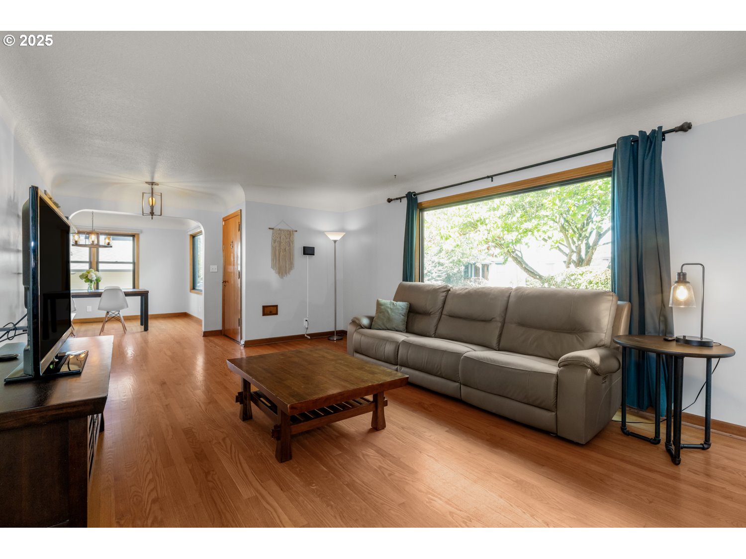 4016 Southeast Cora Street Portland, OR 97202 - Photo 5 of 30 a living room with furniture and a flat screen tv