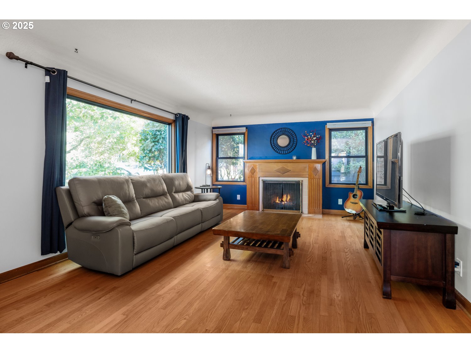 4016 Southeast Cora Street Portland, OR 97202 - Photo 6 of 30 a living room with furniture and a fireplace