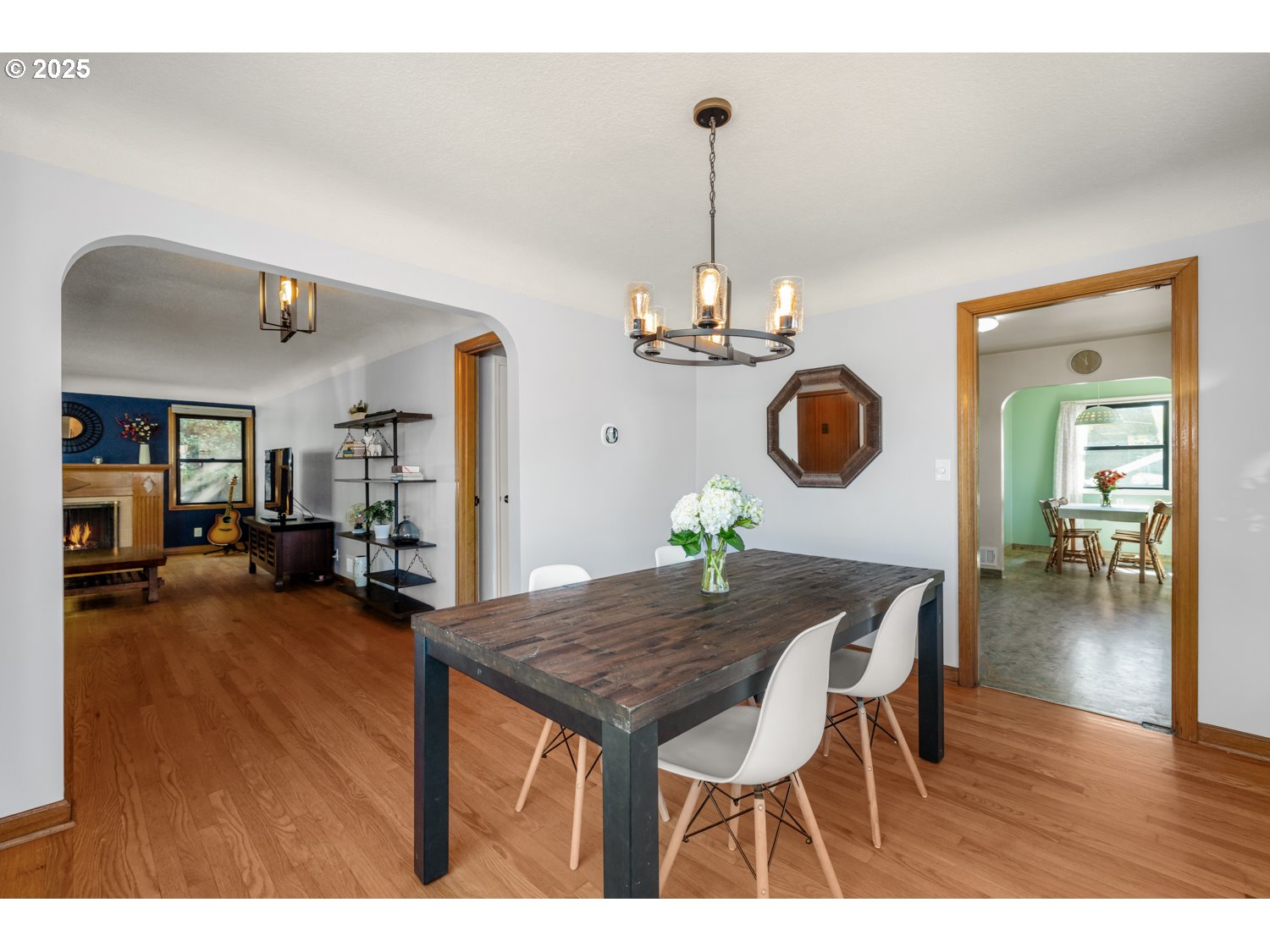 4016 Southeast Cora Street Portland, OR 97202 - Photo 8 of 30 a view of a dining room and livingroom with furniture wooden floor a chandelier