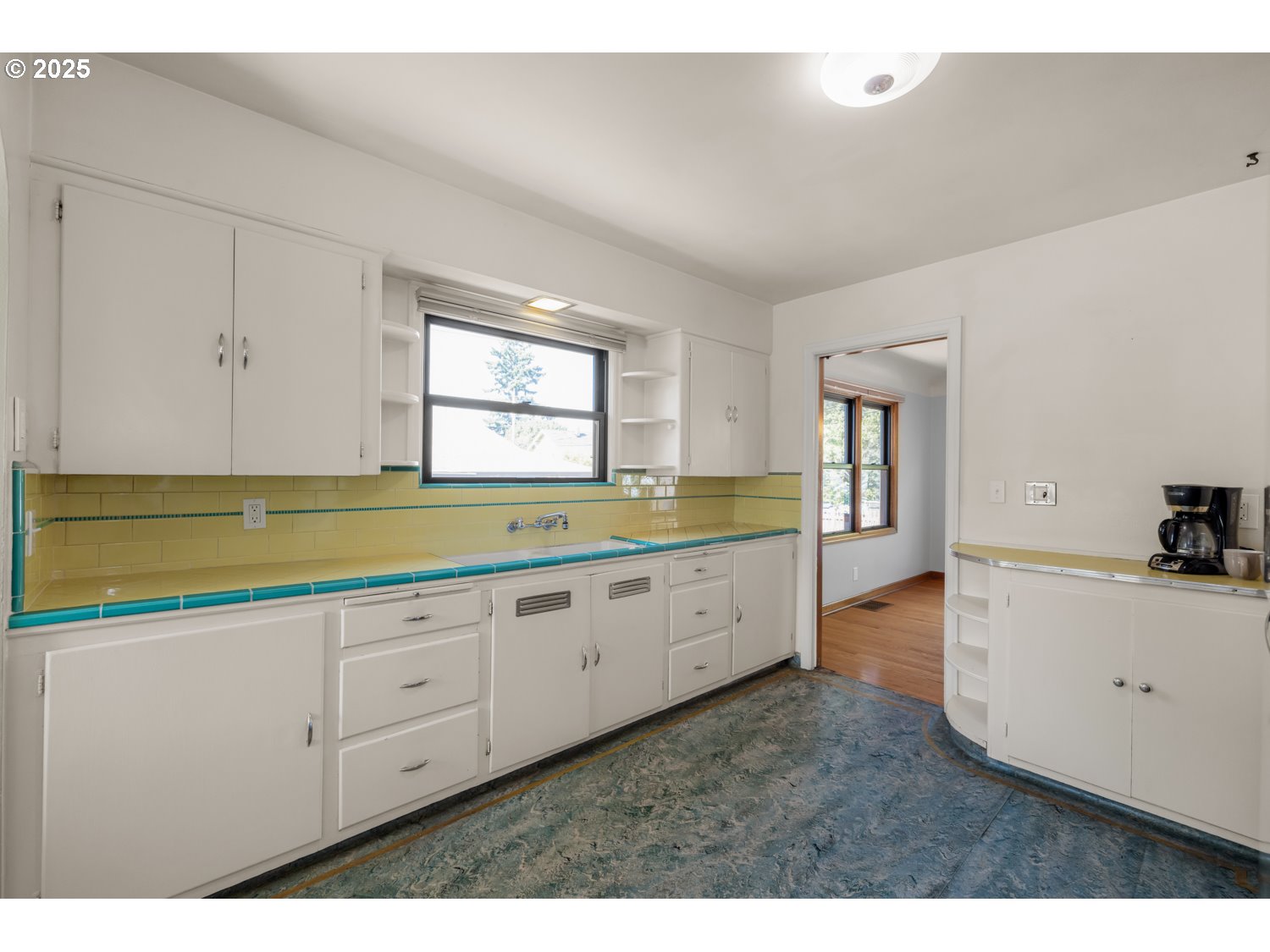4016 Southeast Cora Street Portland, OR 97202 - Photo 10 of 30 a kitchen with granite countertop white cabinets and a sink