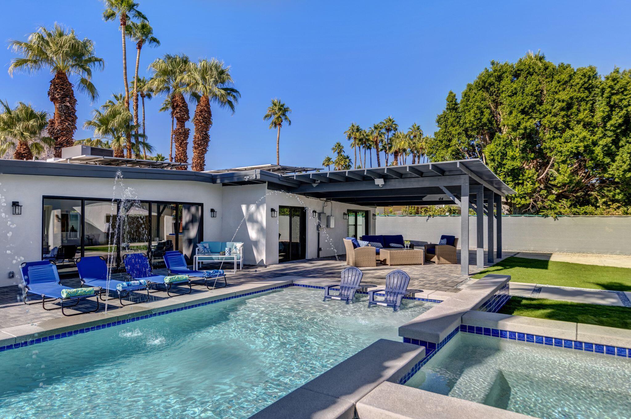 690 South Grenfall Road Palm Springs, CA 92264 - Photo 2 of 92 a view of a chairs and tables in the patio and a fountain in patio
