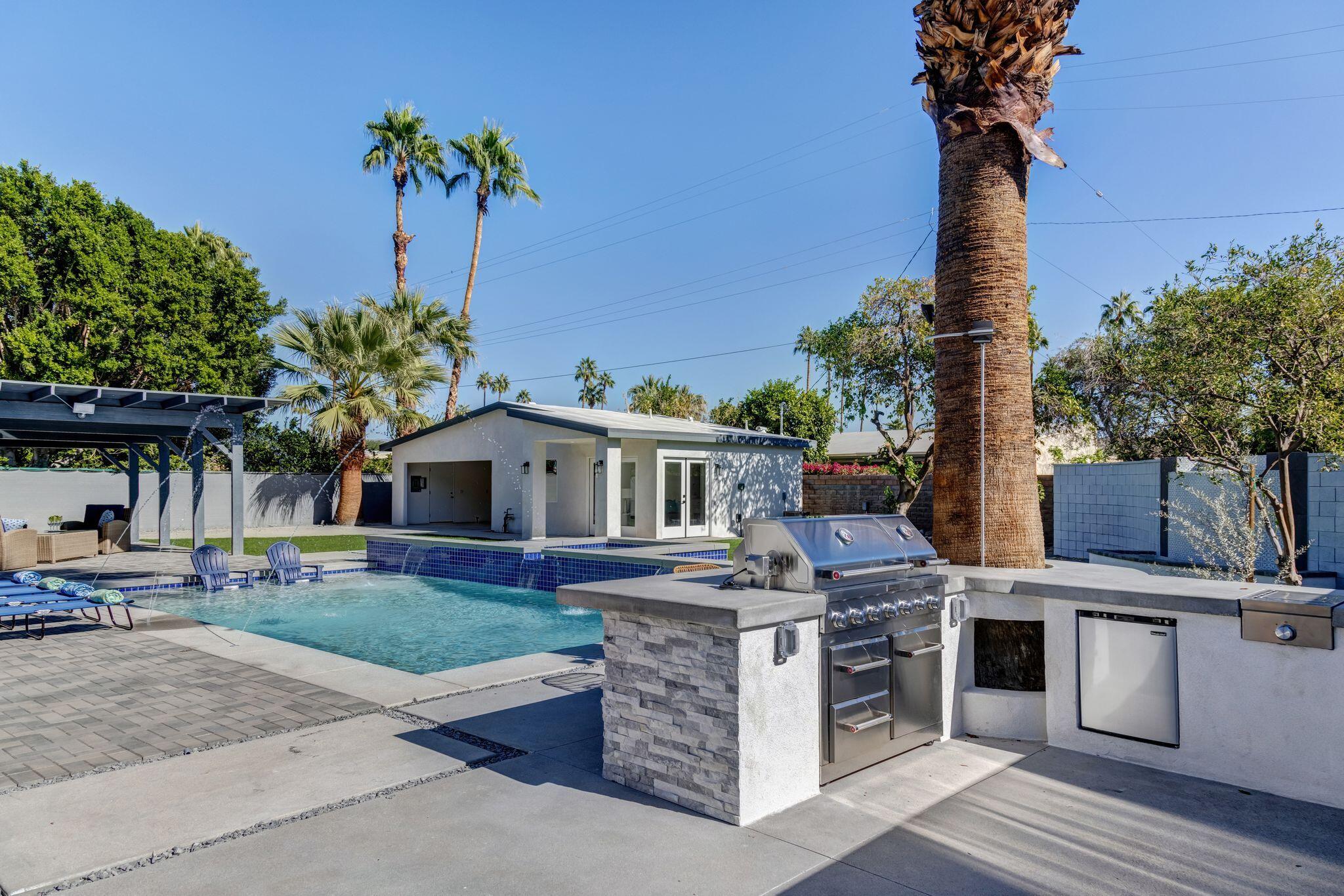 690 South Grenfall Road Palm Springs, CA 92264 - Photo 30 of 92 a front view of a house with a garden and trees